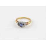 An 18ct. gold, sapphire and diamond cluster ring, having navette form white gold mount set central