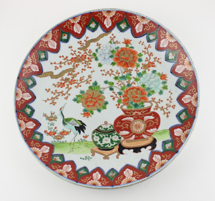 A Japanese Meiji period porcelain charger, decorated with blossom and Crane, diameter 37.1cm.