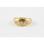 An 18ct. yellow gold and diamond ring, gypsy set three graduated old cut diamonds, shank