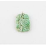 A Chinese mottled green jade pendant, c.1920's, carved and pierced with stylised foliage, height