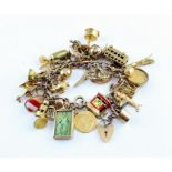 The Lakonia Charm Bracelet: A 9ct. rose gold curb link charm bracelet with heart padlock clasp,