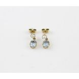 A pair of 9ct. gold, pearl and aquamarine drop earrings, each having claw set pearl suspending