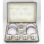 An Edwardian cased set of six silver coffee can holders, by Philip Hanson Abbot, assayed
