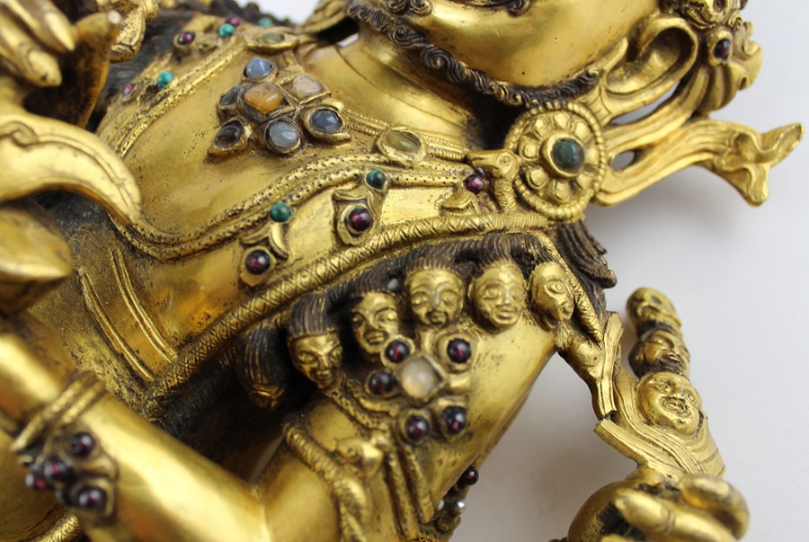 An early 20th century Sino-Tibetan gilt bronze of a seated Mahakala, the wrathful Diety having a - Image 3 of 8