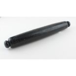 A Victorian folk art black glass rolling pin, of typical gently convex form, engraved with twin
