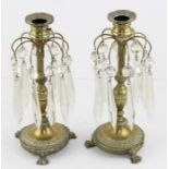A pair of Regency brass and glass pendent candle sticks, each with prism and pearl drops, urn shaped