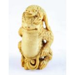 A Chinese Republican Period ivory carving of a Toad, realistically carved with a crouching toad with