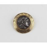 A Greek silver and 18ct. yellow gold brooch, having a silver reproduction ancient Greek coin