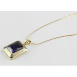 A Turkish Kocak 14ct. yellow gold and purple stone pendant, the two-tone finish rectangular