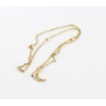 A 15ct. yellow gold gold necklace, formed from sets of oval links alternating larger beads,