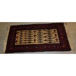 A 20th century Turkish rug , with unusual design of animal and figures on a beige ground, within