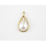 A 14ct. gold, mother of pearl and diamond pearl string clasp/pendant, fashioned as a stylised pear