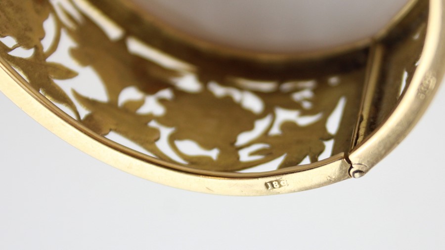 An 18ct. yellow gold pierced and hinged bangle, of typical ovoid form, each half having pierced - Image 4 of 4