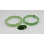 A green jade bangle, diameter 7.7cm x width 1.3cm, in fitted box, together with a similar mottled
