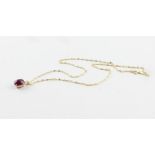 A 9ct. yellow gold, cabochon ruby and diamond pendant, four claw set oval cabochon ruby (ruby weight
