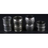 Four pairs of circular silver napkin rings, to include; a pair of Victorian silver napkin rings by