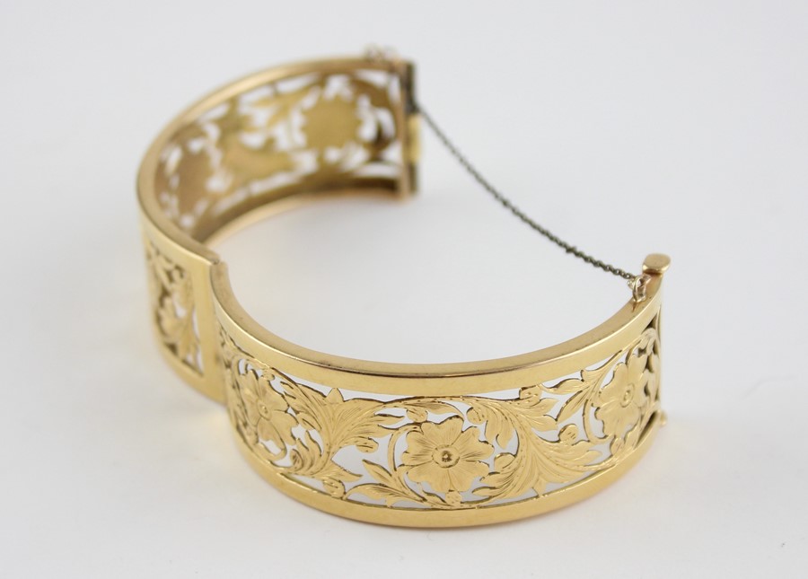 An 18ct. yellow gold pierced and hinged bangle, of typical ovoid form, each half having pierced - Image 3 of 4