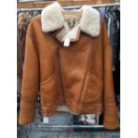 As new; a sheepskin bomber jacket, the tan outer of the jacket in a sheepskin leather metal zip,