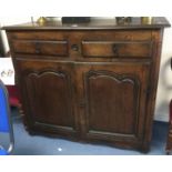 An early 18th century oak sideboard with two drawers and two cupboards.