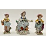 A Sitzendorf female flower seller, seated 5 inches tall / 13 cms approx,