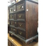 An 18th Century and later oak chest of drawers, fitted with four long graduated drawers,