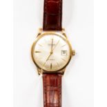 A Garrard 9ct gold gents watch, champagne dial, batons and date window, circa 1960's,