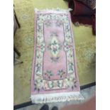 A contemporary pink ground floral rug, of Chinese origins,