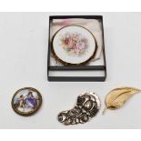 A Trifari gilt brooch, a Limoges 19th Century brooch A/F, a white metal floral brooch,