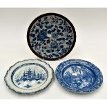 Two 18th Century blue and white plates along with a bronze crackle glaze 1920's plate,