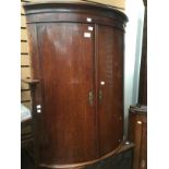 A 19th Century mahogany bow fronted corner cabinet,