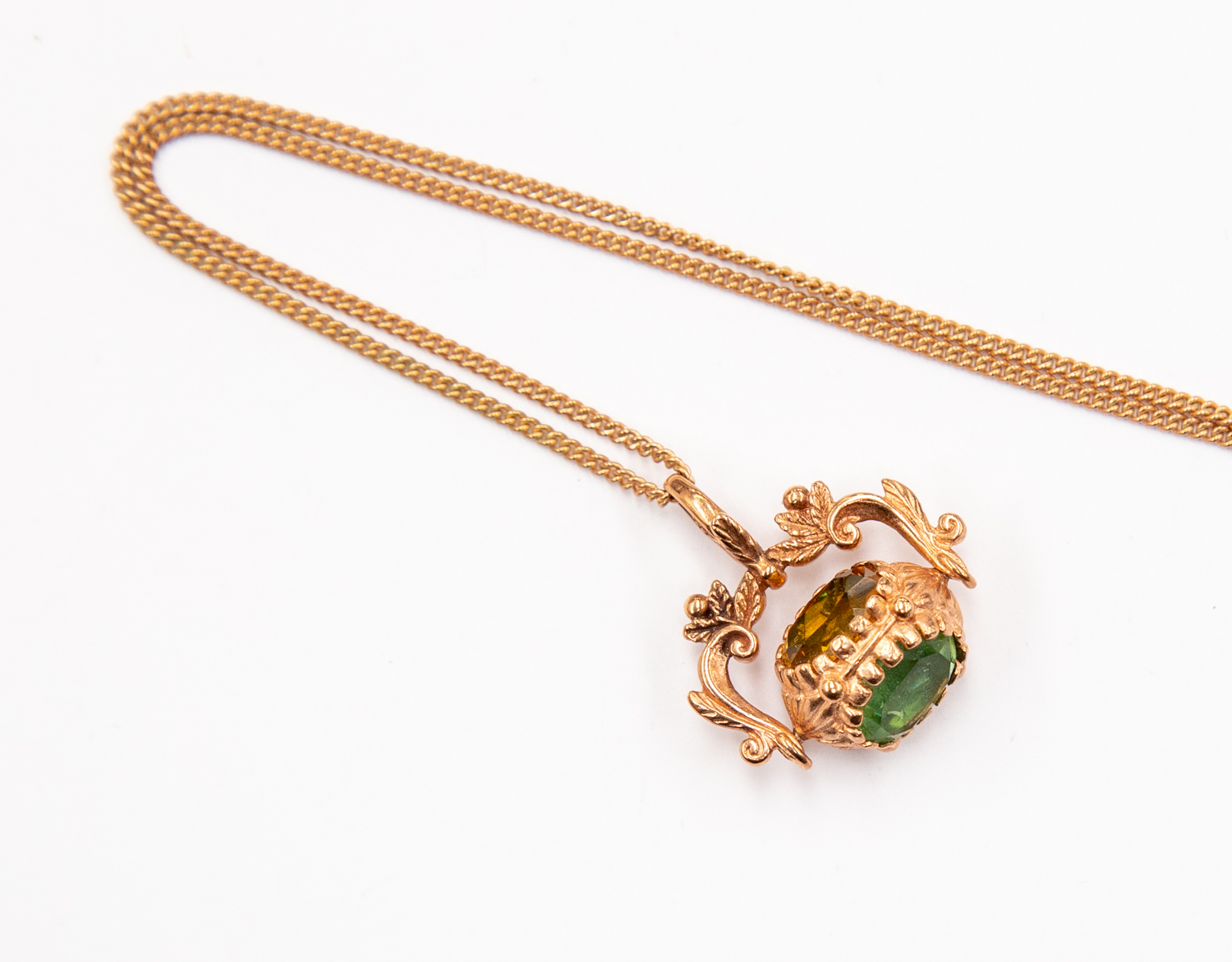 A 9ct rose gold seal fob pendant set with coloured paste stones, on a rose gold chain,