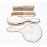 A George V silver four piece dressing table brush set, London 1927, comprising clothes brush,