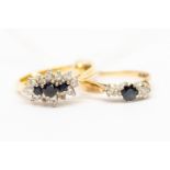 A sapphire and diamond cluster ring set with three sapphires with a diamond set border, 18ct gold,