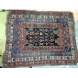 A late 19th / early 20th Century hand knotted woollen rug, with a geometric design,
