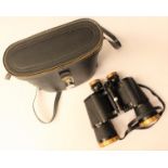 A pair of binoculars with leather carrying case,