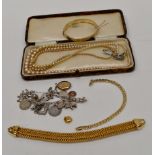 A quantity of assorted costume jewellery to include silver charm bracelet, rolled gold bangle,