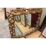 A Florentine carved and pierced giltwood wall mirror