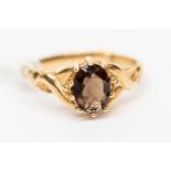 A 9ct gold ring claw set with an oval smoky quartz, size N,