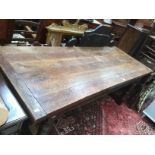 Large carved oak dining table with substantial turned legs together with four ladder back chairs.