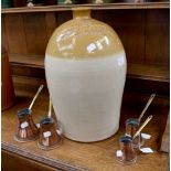 W Faulkner stone ware bottle with four copper and brass measuring pots