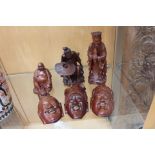 Three Japanese hardwood Noh masks, a hardwood Bhudda,