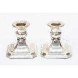 A pair of silver candle sticks,