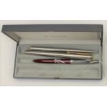 A Parker 95 fountain pen and a ball point pen together with another ball point pen,