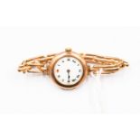 A 1930's 9ct rose gold ladies watch, round dial, numerals, white enamelled dial,