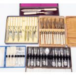 Two boxed sets of fish eaters, an Edwardian ivory handled bread knife and fork, boxed,