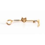 A 15ct gold hunting stick pin, as a riding crop with fox head, stamped 15ct, approx 4.
