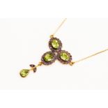 Silver gilt pendant necklace with 9ct chain set with three peridot with amethyst surrounds with a