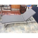 A contemporary pair of reclining ratten grey deck chairs,