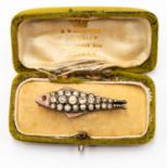 An Edwardian paste set fish brooch, white metal with rose gold details, length approx 45mm,