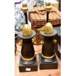 A pair of cast iron and bronze Empire style candlesticks, with wrythen pommels and later shade,